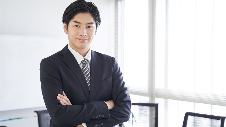 Japanese businessman standing in an office, representing business ownership in Japan